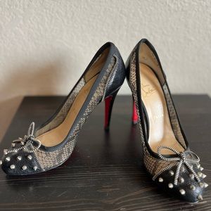 Black Christian Louboutin heel with studs, lace and zipper bow.